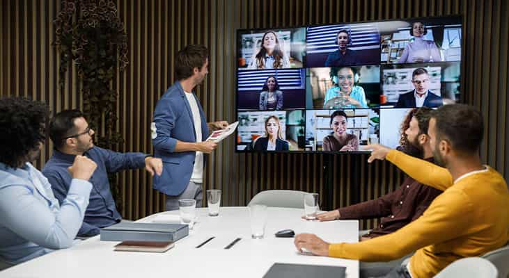 In-room and remote participants in a hybrid meeting do a pulse check icebreaker